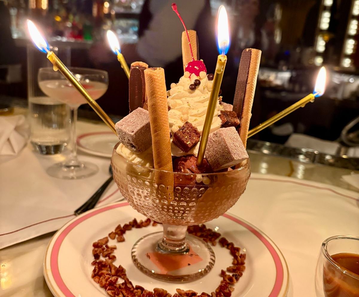 An ice cream sundae with birthday candles.