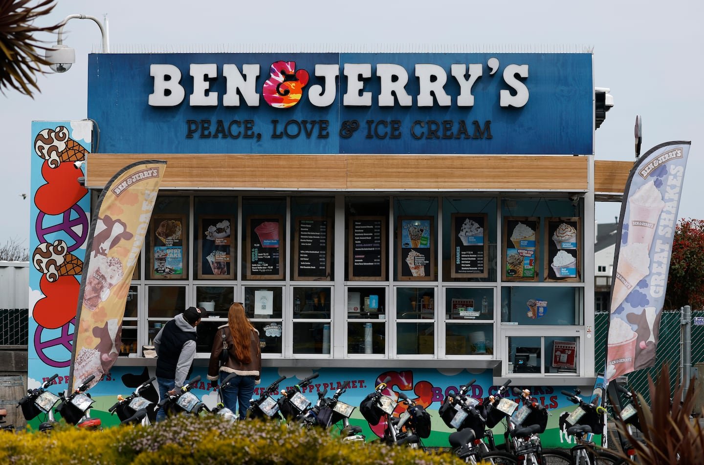 Customers place an order at a Ben and Jerry's ice cream shop on March 19 in San Francisco, Calif.