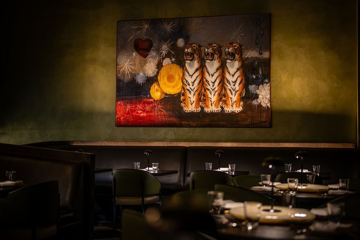Tiger painting on a green wall at 88 Club.