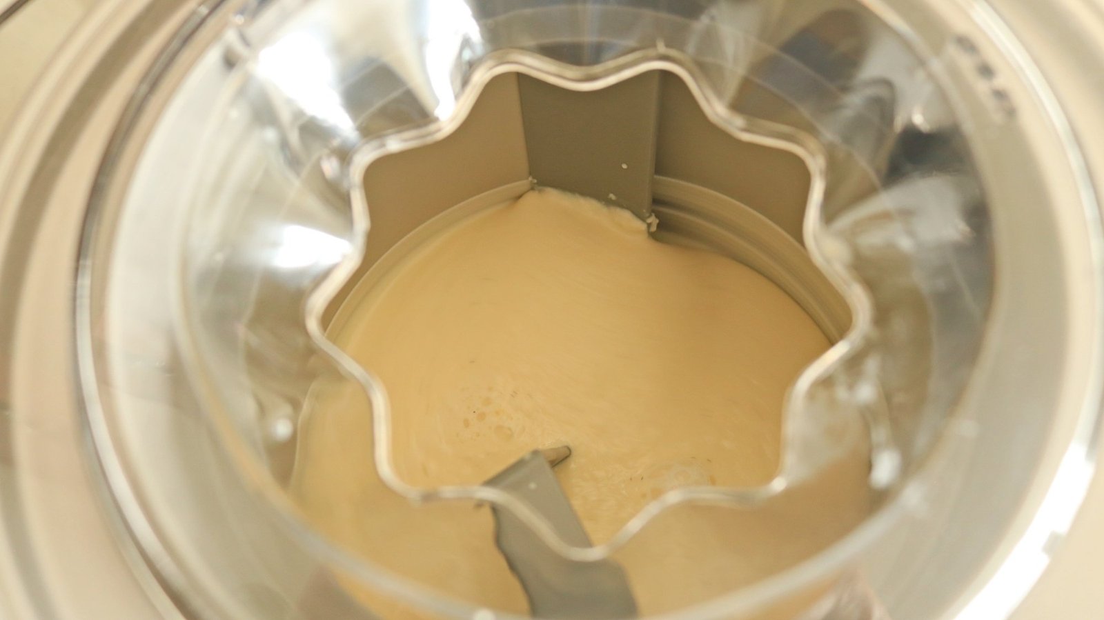 Vanilla ice cream mixing inside of the Cuisinart Pure Indulgence ice cream maker.