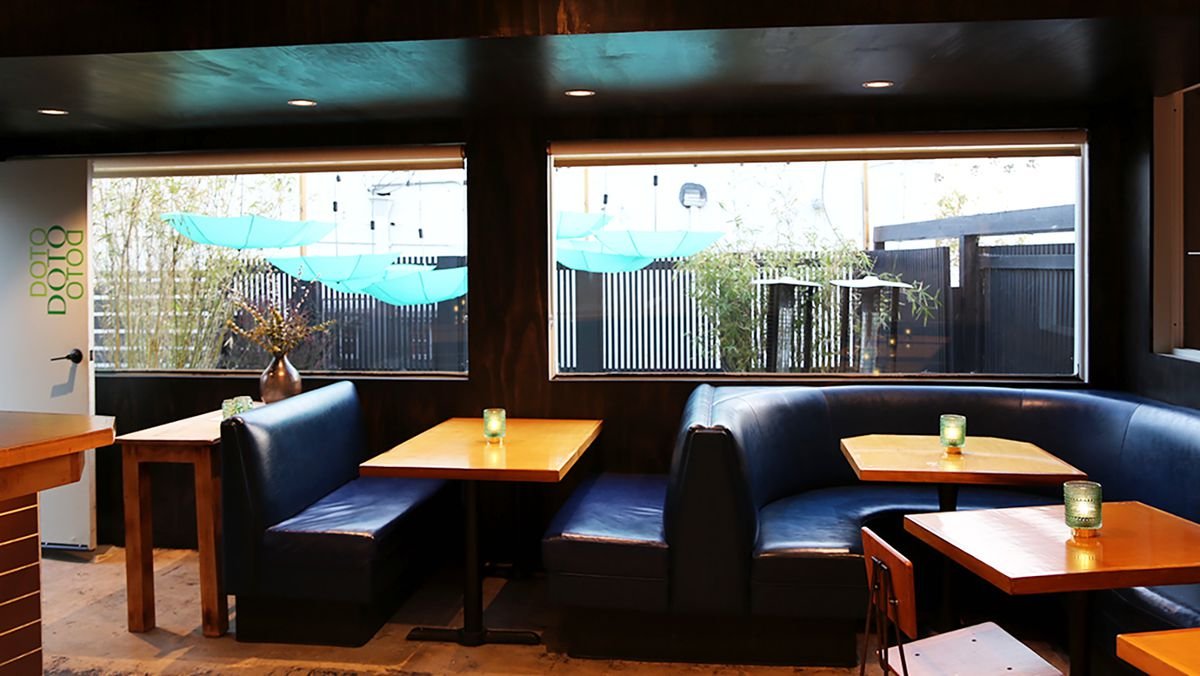 An all-day restaurant with blue banquettes at Doto.