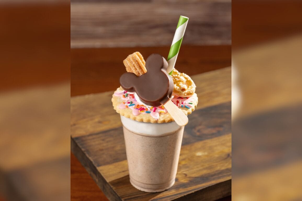 A Churro Milk Shake at EPCOT, topped with a Mickey Mouse-shaped chocolate, cookie, and colorful sprinkles.