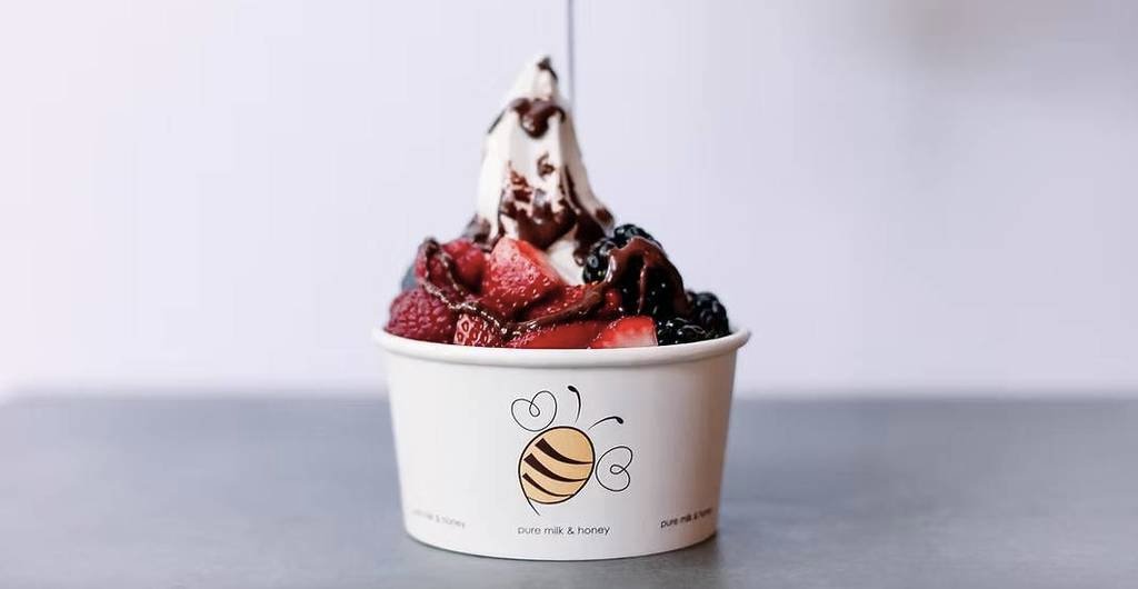 Image shows a fruit-topped ice cream in a cup at Pure Milk & Honey in Dallas