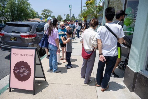 People wait in line for a free scoop of ice...