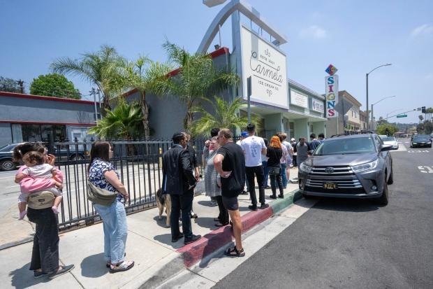 People wait in line for a free scoop of ice...