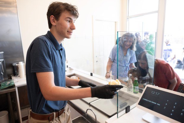 Cameron Cox dishes out free ice cream at Carmela Ice...