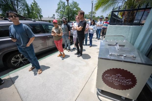 People wait in line for a free scoop of ice...