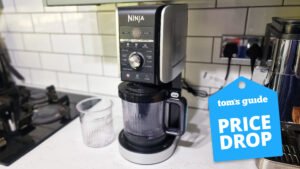 the ninja creami photographed in a kitchen with a tom's guide deal badge on top
