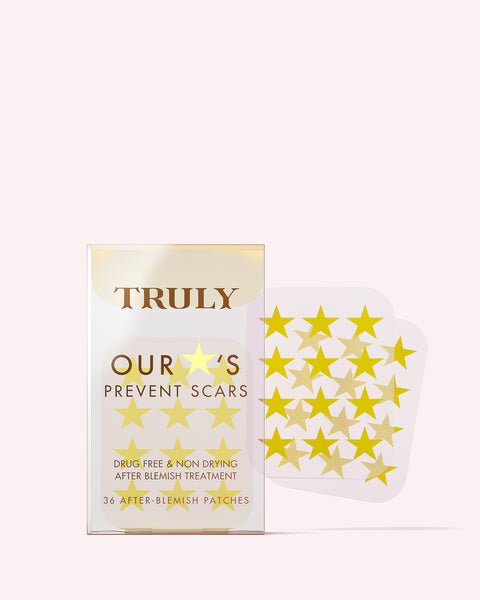 A clear plastic box labeled Our Stars Prevent Scars Blemish Patches by Truly Beauty holds yellow star-shaped hydrocolloid patches, with two sheets of star patches next to the box on a light pink background.