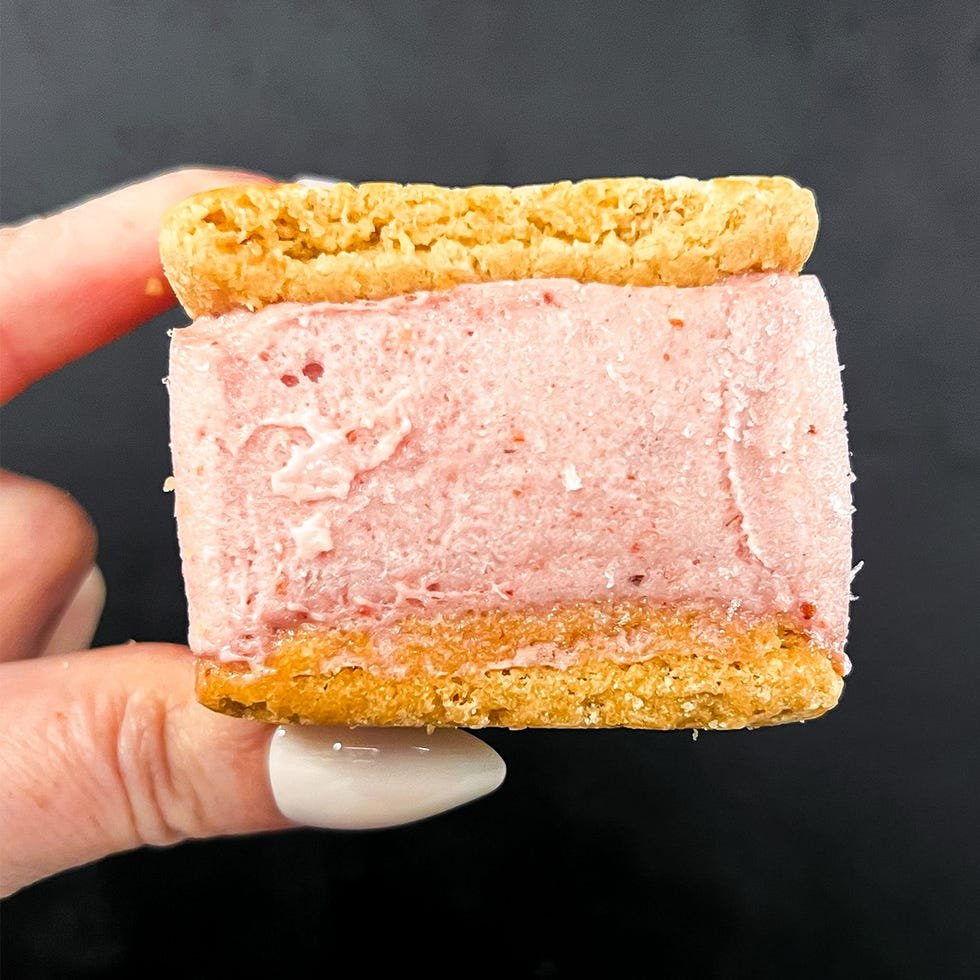 hand holding strawberry shortcake ice cream sandwich